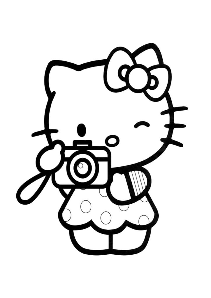 Coloriage Hello Kitty portant une robe à pois et tenant un appareil photo devant son visage, l'œil fermé pour viser, dessin à colorier pour enfants